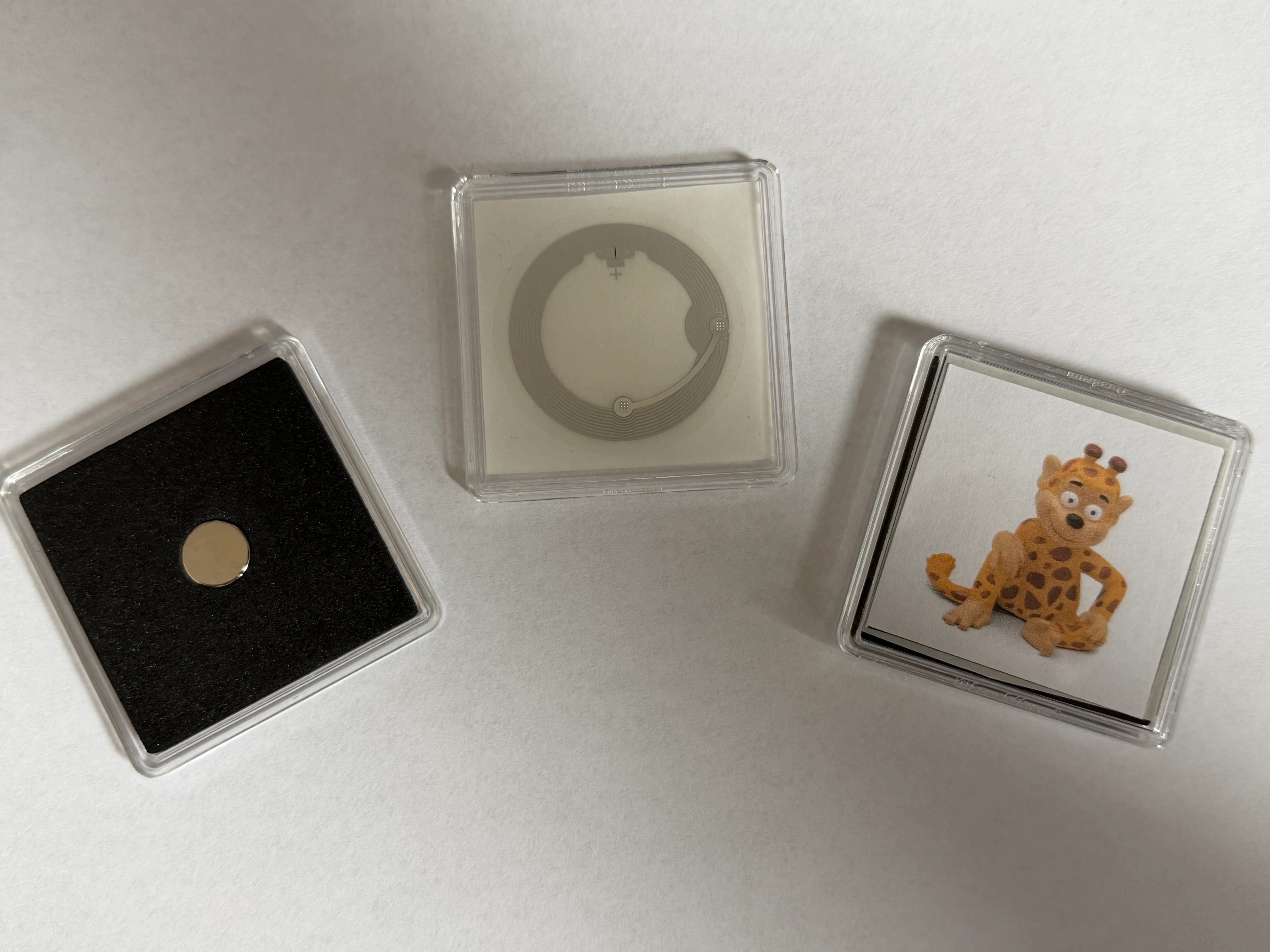 A photo of QUADRUM capsules containing NFC tags and custom images